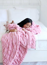 Hugs Cookie Pink Blanket on a bed, showcasing its cozy and soft texture for ultimate comfort.