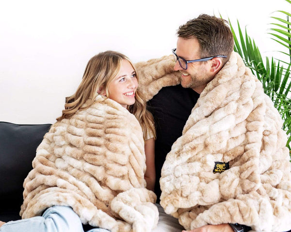 Father and daughter snuggled up in Minky Couture's Cotton Candy Caramel Hugs blanket.