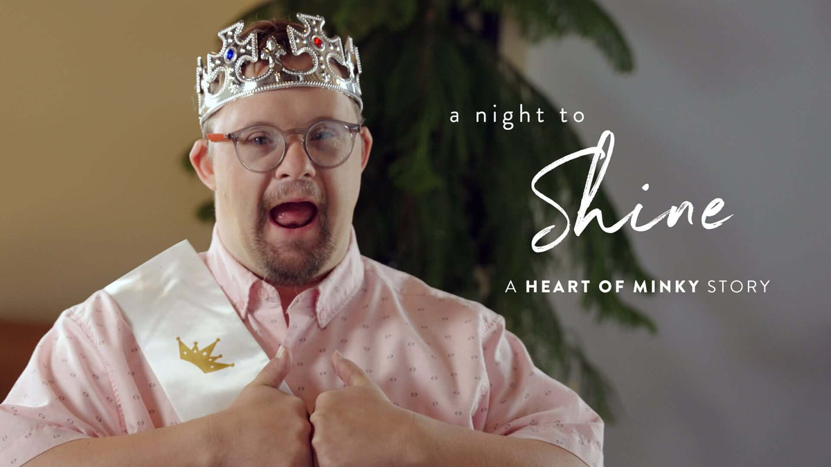 A young man crowned at a Night to Shine celebration, showcasing the Heart of Minky Story.