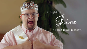 A young man crowned at a Night to Shine celebration, showcasing the Heart of Minky Story.