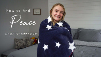 how to find Peace A HEART OF MINKY STORY, woman smiling in star-pattern blanket with a cozy bedroom backdrop