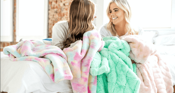 QUIZ: Build A Bedroom & We'll Tell You The Perfect Minky To Go With It - two friends enjoying cozy blankets in a bedroom.