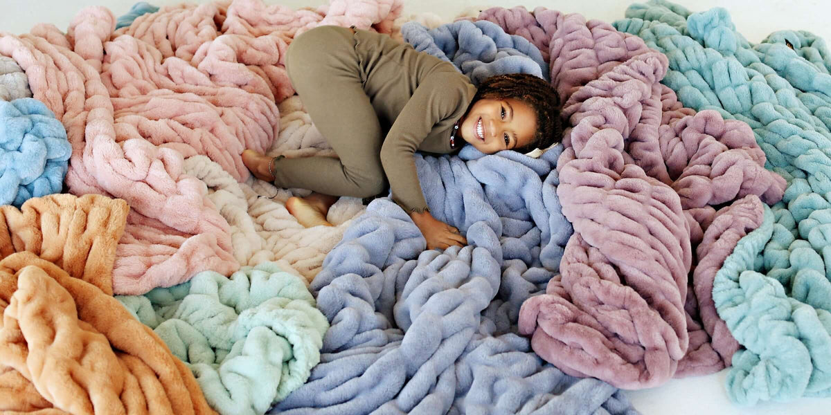 Child enjoying cozy blankets in pastel colors, perfect for Fall Recipes We Love and holiday cooking.