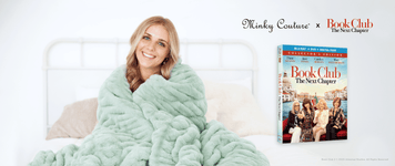 Minky Couture x Book Club: The Next Chapter blanket with a happy woman cozying up to watch the movie.