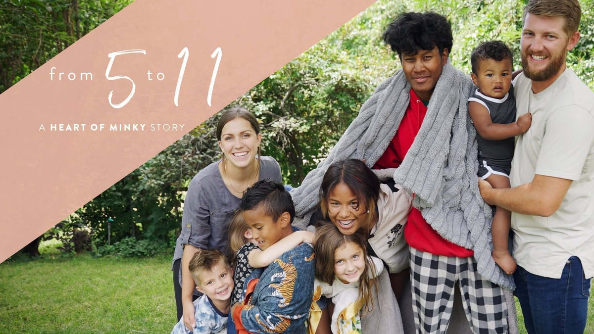 From 5 to 11 - A HEART OF MINKY STORY featuring a joyful family in a playful outdoor setting.