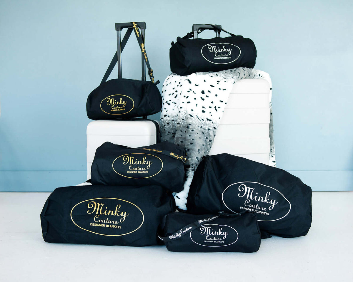 Minky Couture travel bags filled with blankets, ideal for comfort while traveling on a plane.