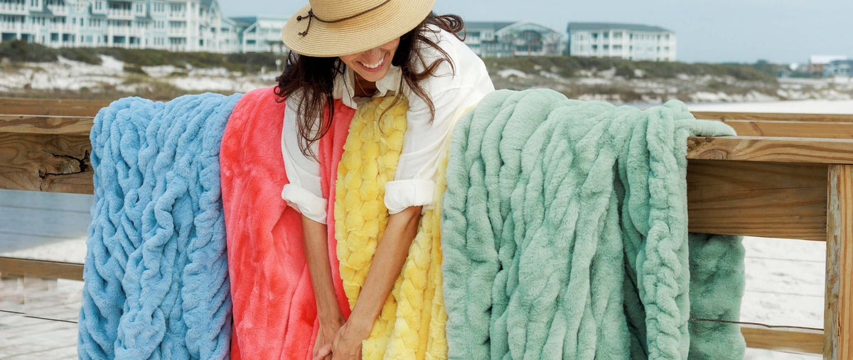 The Blanket You Choose Reveals More About You Than You Think, colorful blankets on display at the beach.