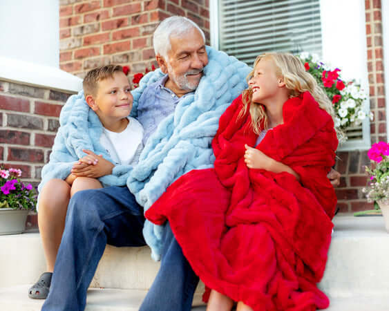 The Best Gift to Give for Father's Day! A grandfather enjoying cozy time with his grandkids wrapped in Minky Couture blankets.