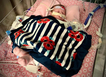 Heart of Minky: Miracle Morgan in hospital, wrapped in a colorful blanket, surrounded by medical equipment.