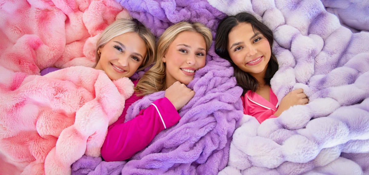 Bridesmaid Proposal Ideas: The Best Gifts to Pop the Question with friends snuggled in colorful blankets.
