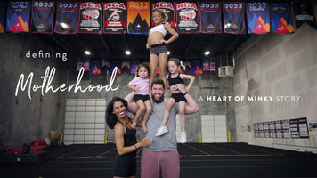 Heart of Minky Story - "Defining Motherhood" image featuring a joyful family in a gym setting.
