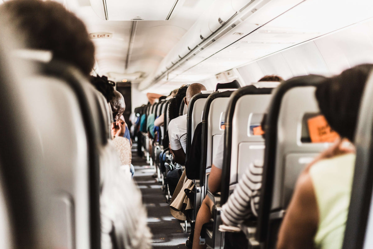 Sit Back and Relax - 14 Top Tips for Comfortable Travel onboard an airplane with passengers seated.