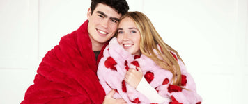 Traditional Anniversary Gifts for Him & Her couple sharing love wrapped in cozy blankets.