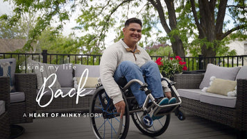 Heart of Minky Story - Taking My Life Back, person in wheelchair smiling on patio with flowers.