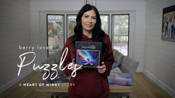 Heart of Minky Story Berry Loved Puzzles: Woman holding Berry Loved Puzzles box in a bright room.