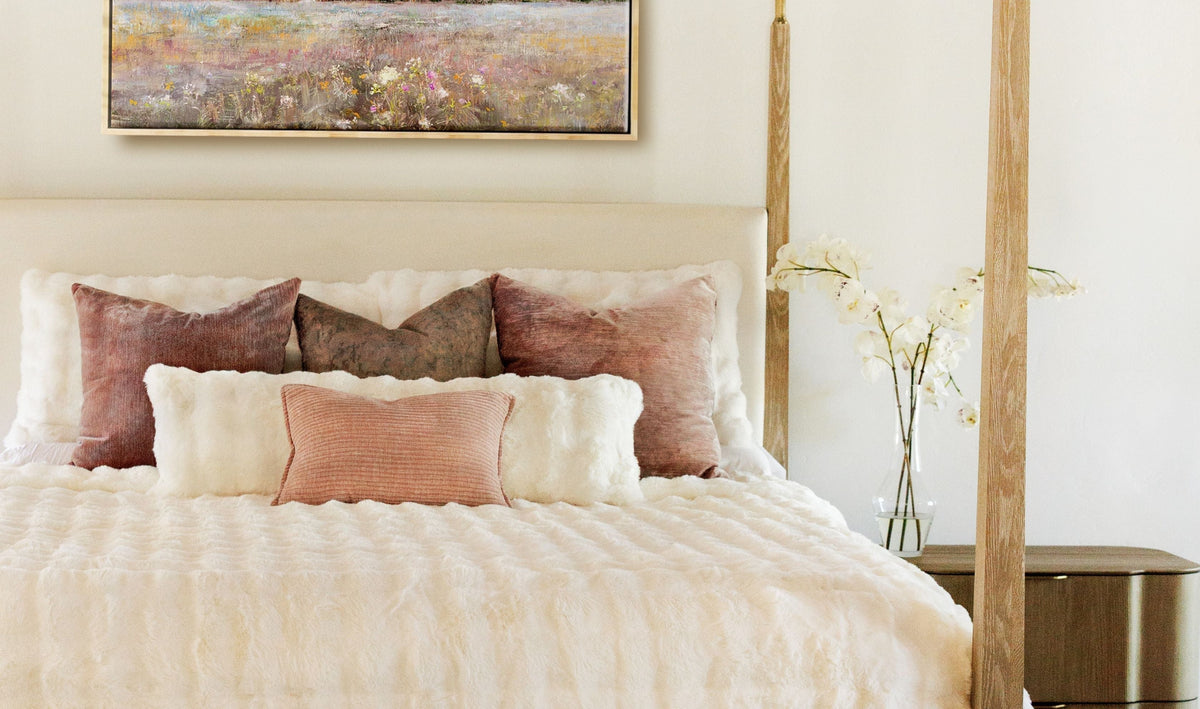 Spring Bedroom Ideas featuring a cozy bed with decorative pillows and a calming artwork above.