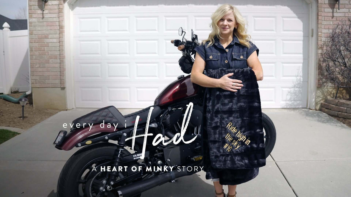Heart of Minky Story - "Every Day I Had" image featuring a mother holding a minky blanket next to a motorcycle.