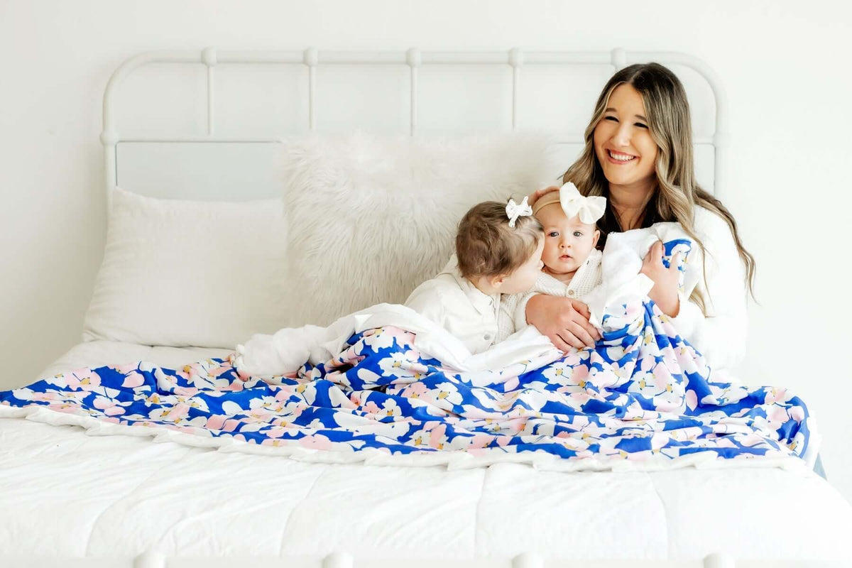 A mother enjoying quality time with her two children on a bed, highlighting the benefits of personalized gifts.