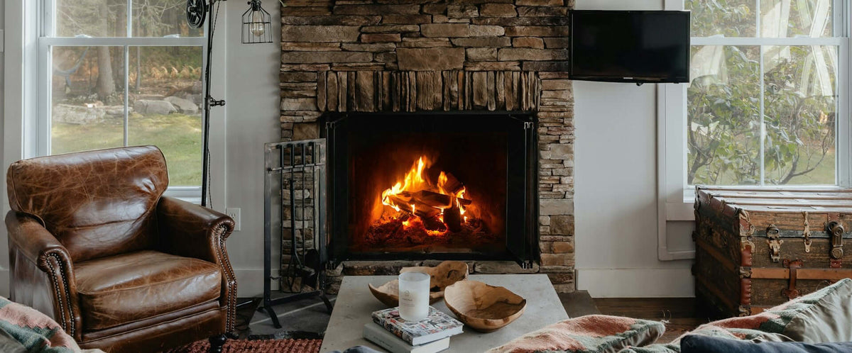 Cozy Fireplace Ideas featuring a warm stone fireplace with a flickering fire and a cozy seating area.