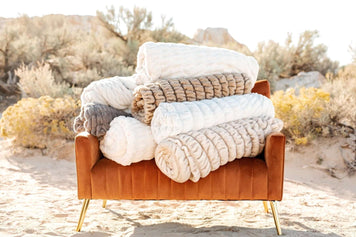 FAQs about Minky Couture blankets-What is a Minky blanket? Minky blankets displayed on a stylish sofa in a natural setting.