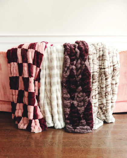 Minky Couture faux fur blankets displayed in multiple colors and textures.