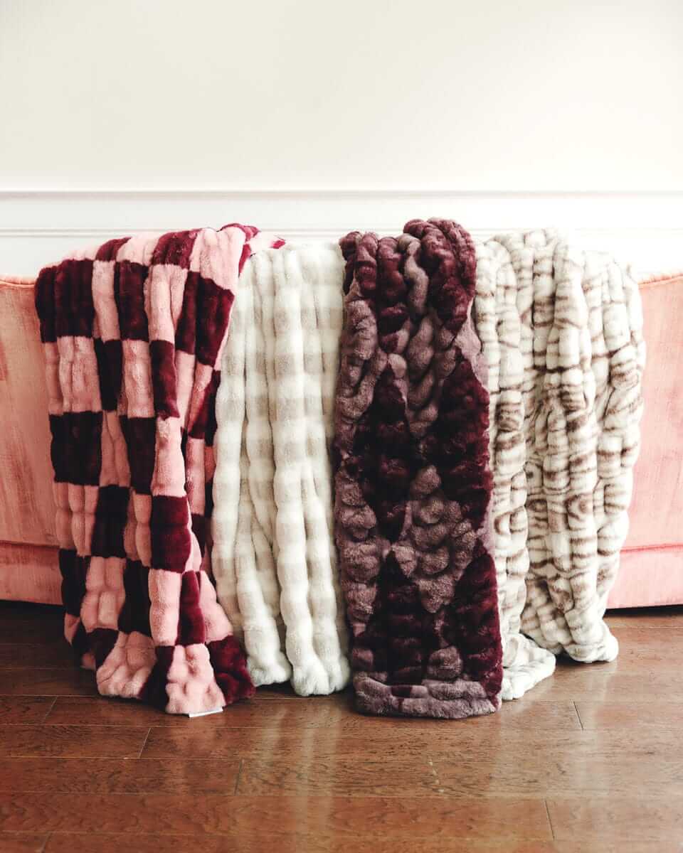 Minky Couture faux fur blankets displayed in multiple colors and textures.