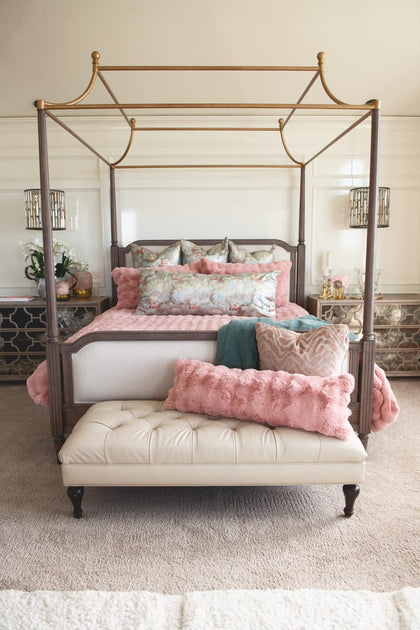 Ballet Rose Cloud Duvet displayed on a luxurious canopy bed with soft blush pillows and a cozy throw.