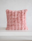 Ballet Rose Cloud Sham in soft blush color on a minimalist table, highlighting its plush texture and elegant design.