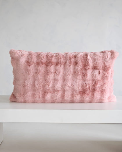 Ballet Rose Cloud Sham on a table showcasing its soft blush color and plush texture.