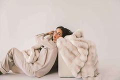 Model lounging with the luxurious Extreme Ultra Cloud Ancient Scroll Blanket, showcasing its softness and elegance.