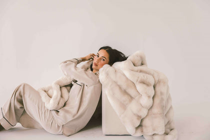 Model lounging with the luxurious Extreme Ultra Cloud Ancient Scroll Blanket, showcasing its softness and elegance.