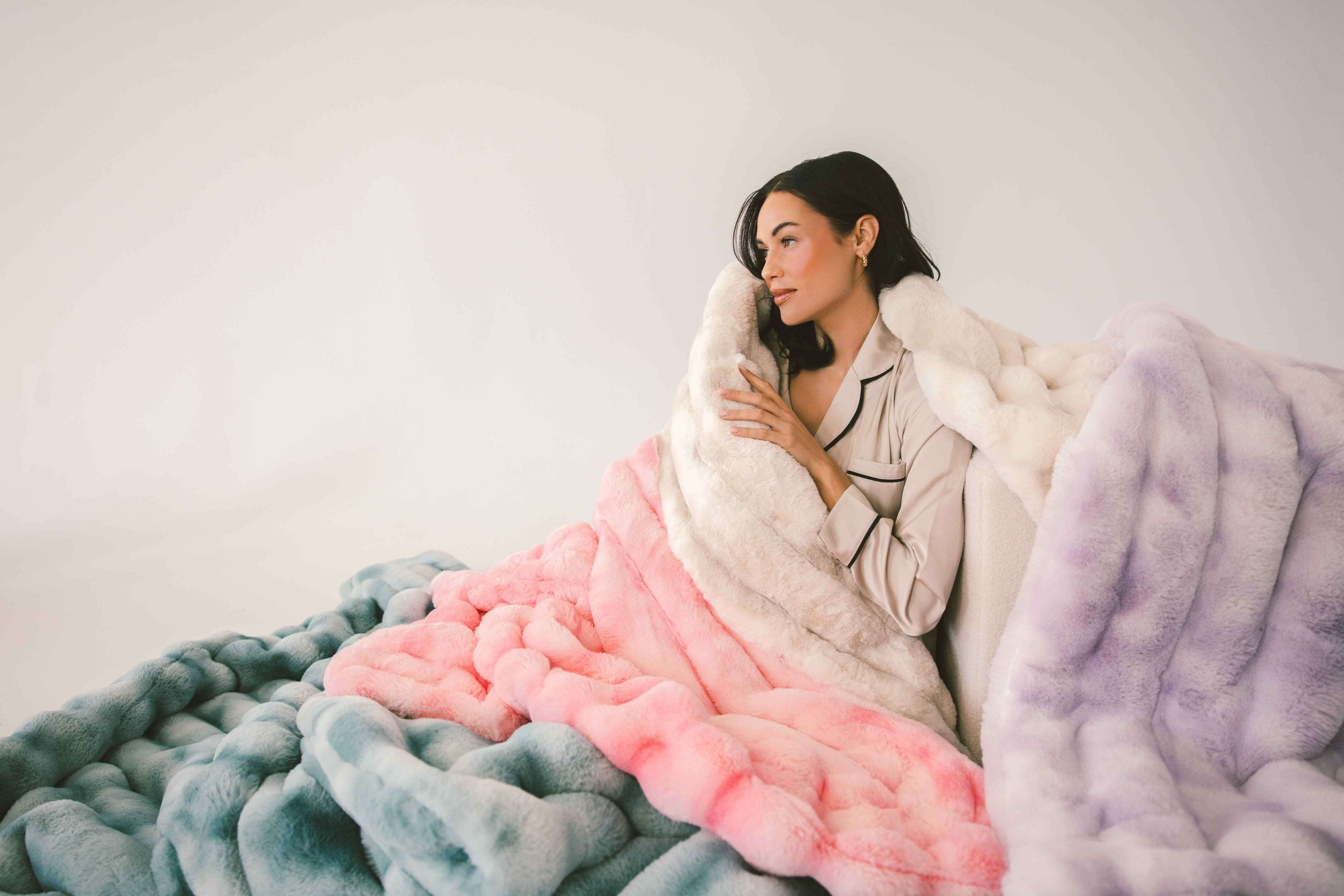 Model wrapped in the Extreme Ultra Cloud Blanket, showcasing its softness and elegant design.