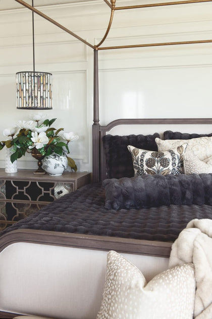 Charcoal Cloud Sham on a beautifully styled bed with textured pillows and elegant decor.