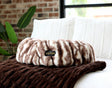 Minky Couture Cloudy Day Brown Pet Bed cover displayed on a cozy bed with soft fabrics and a plant in the background.