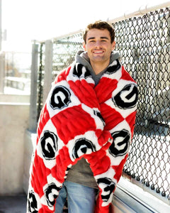 Georgia Bulldogs Blanket wrapped around a smiling man outdoors, featuring a bold red and white checkered pattern.