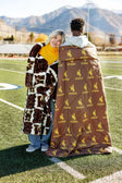 Wyoming Cowboys Hooded Stadium Blanket styled on models enjoying outdoor sports.