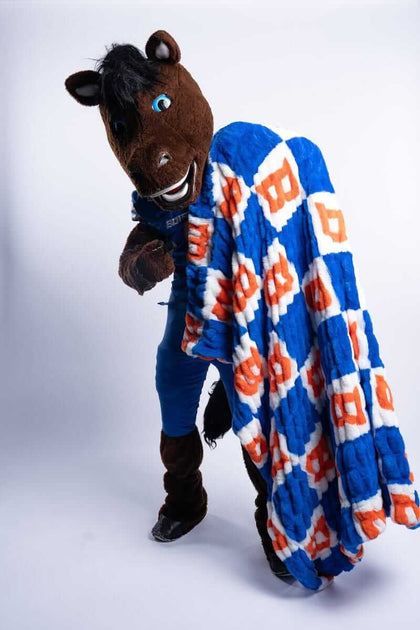 Boise State Broncos Blanket showcased by the Boise State mascot with bold orange and white checkered pattern.