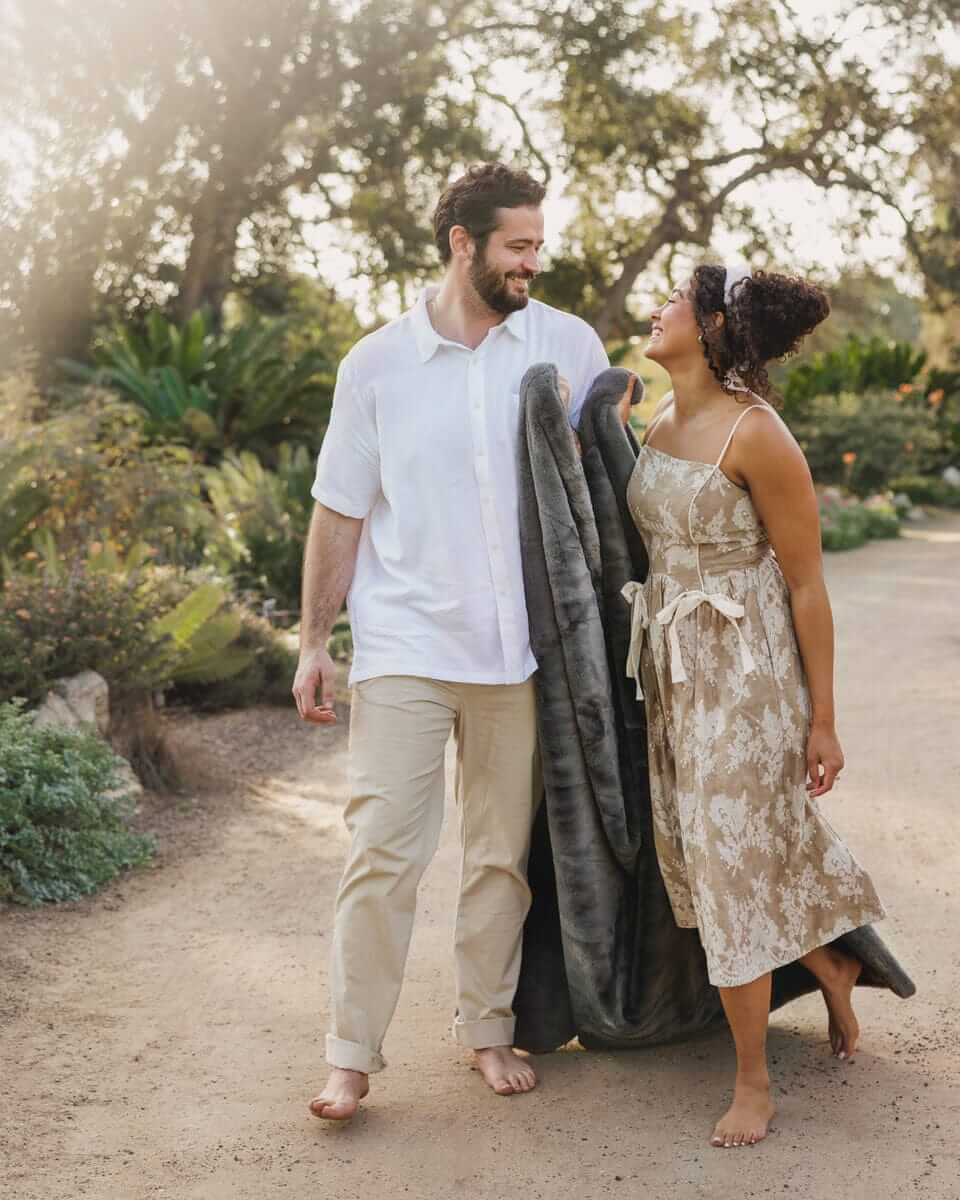 Couple enjoying the outdoors with Lush Steel Gray Blanket, exemplifying style and comfort in a serene setting.