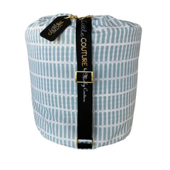 Dash baby sleeping bag rolled with black Little Couture strap and gold hardware.