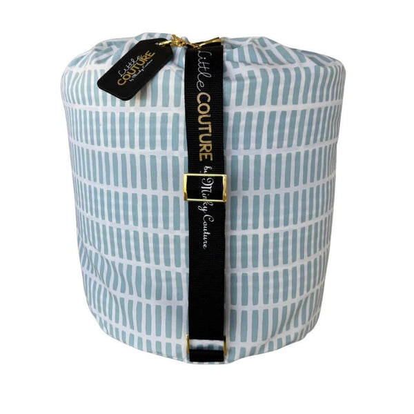 Dash baby sleeping bag rolled with black Little Couture strap and gold hardware.