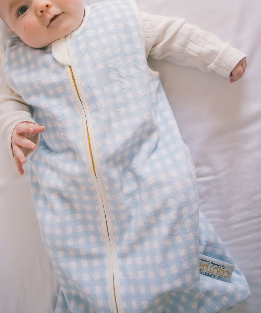 Dusty Blue Gingham Wearable Minky Couture Blanket on an infant, designed for safe and cozy sleep.