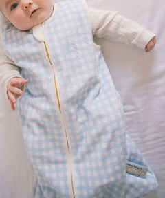 Dusty Blue Gingham Wearable Minky Couture Blanket on an infant, designed for safe and cozy sleep.