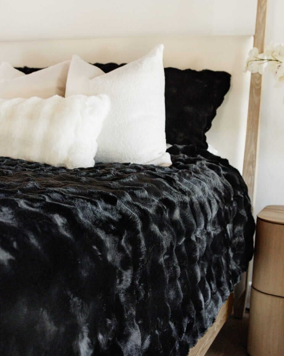 Black Cloud Sham on a stylish bed with plush pillows, adding comfort and sophistication to the decor.