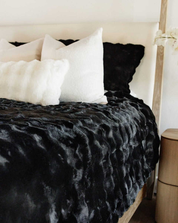 Black Cloud Sham on a stylish bed with plush pillows, adding comfort and sophistication to the decor.