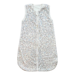 Sleeveless baby sleep sack with a soft floral print in light blue and taupe tones.
