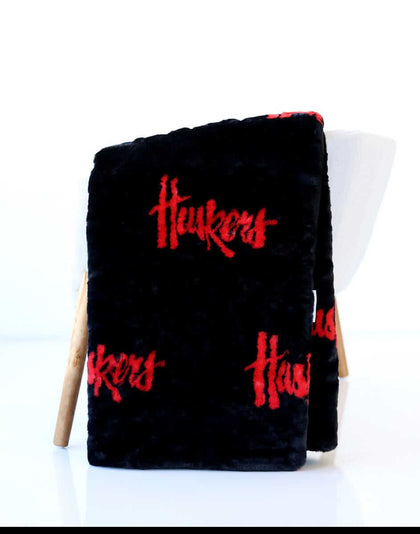 Black Nebraska Huskers Minky Couture blanket with red Huskers text.