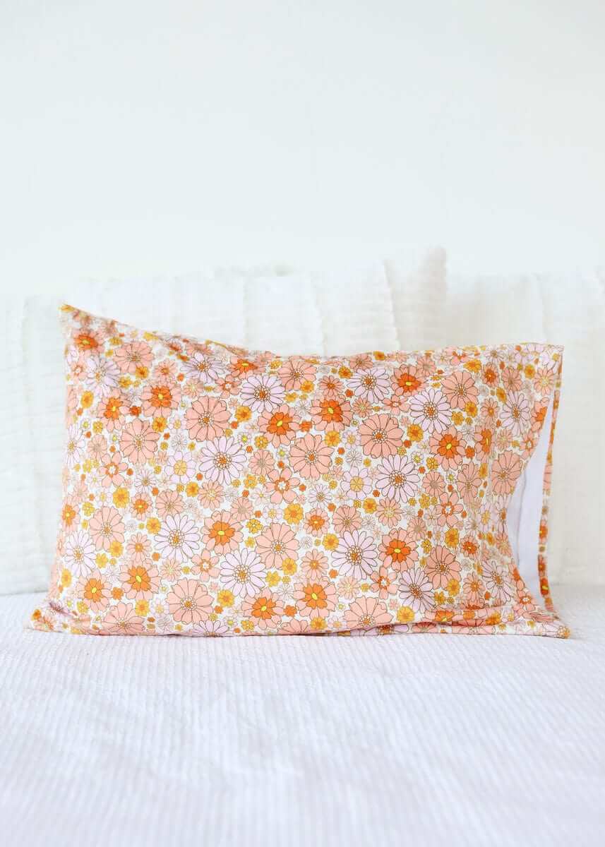Boho Floral Blanket featuring orange and pink floral patterns on a cozy cotton pillow.