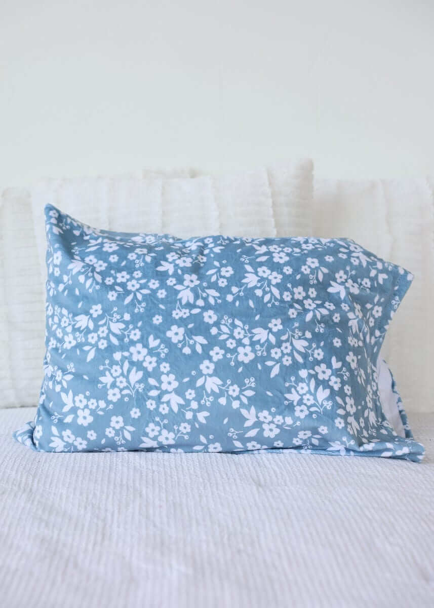 Dainty Floral Blue Blanket with small white flowers on a light blue background, perfect for cozy decor.