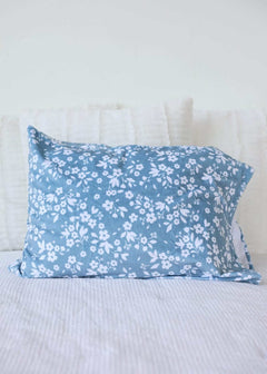 Dainty Floral Blue Blanket with small white flowers on a light blue background, perfect for cozy decor.