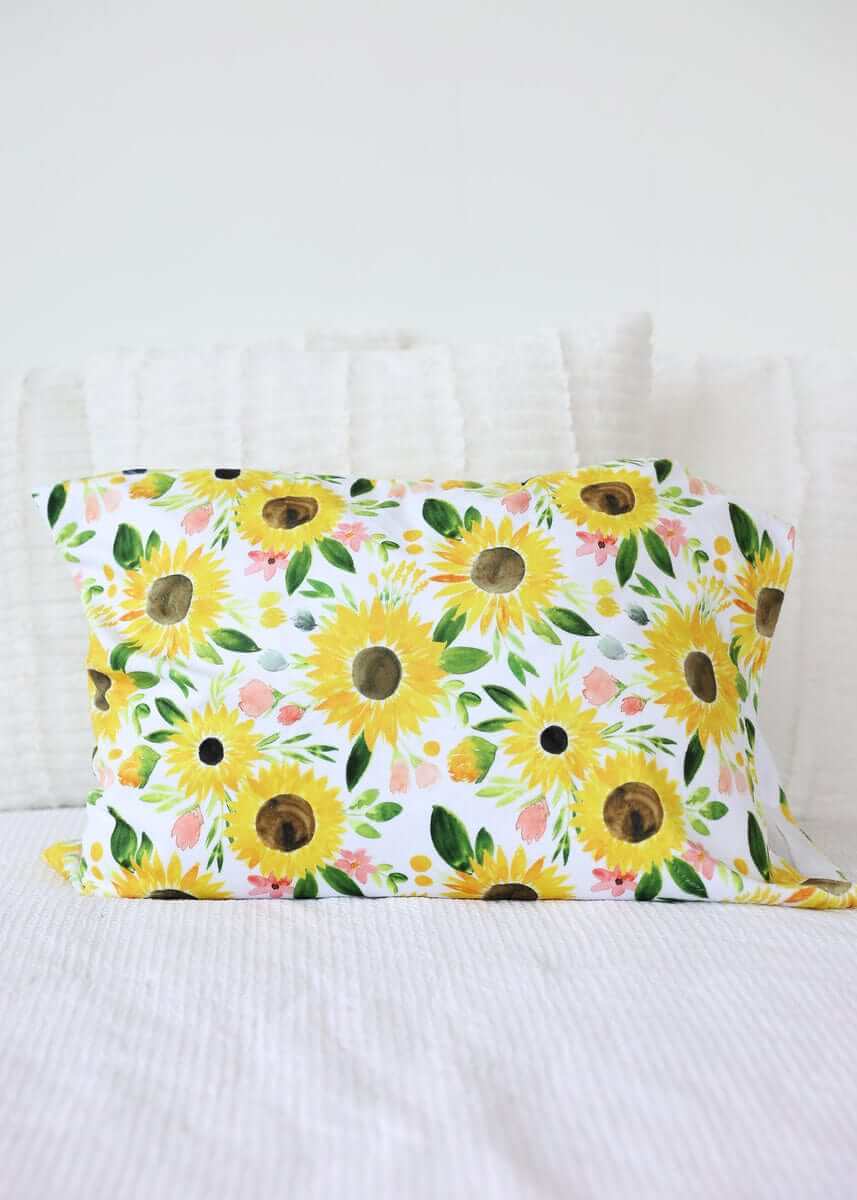 Little Miss Sunshine Blanket featuring vibrant sunflowers and floral accents on a cream background.
